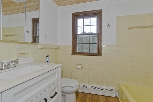 7 Summit Dr, Westfield, MA 01085 - bathroom with tile walls, baseboard heating, vanity, a bath, and wood finished floors