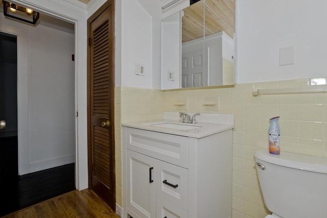 7 Summit Dr, Westfield, MA 01085 - bathroom featuring vanity, wood finished floors, tile walls, and a wainscoted wall