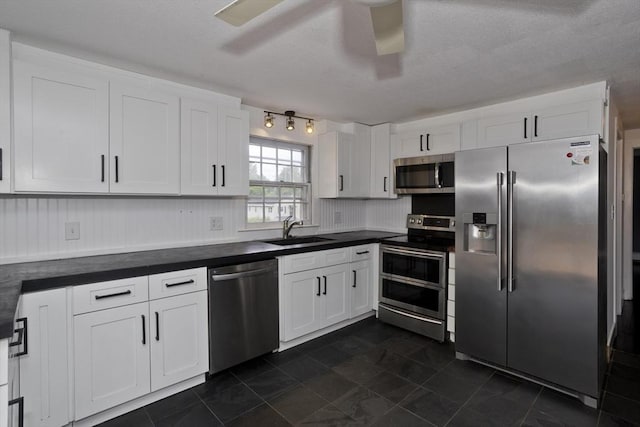 7 Summit Dr, Westfield, MA 01085 - kitchen featuring stainless steel appliances, dark countertops, white cabinetry, and a textured ceiling