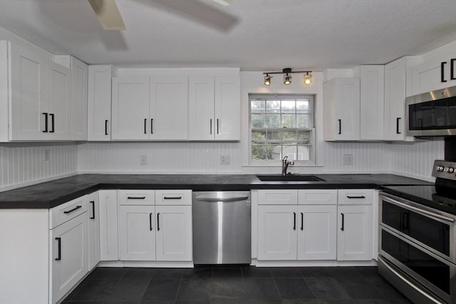 7 Summit Dr, Westfield, MA 01085 - kitchen with appliances with stainless steel finishes, white cabinetry, dark countertops, and dark tile patterned flooring