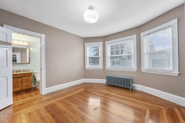 2 Howard St, Braintree, MA 02184 - spare room featuring radiator heating unit, plenty of natural light, and light wood-type flooring
