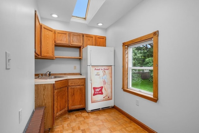2 Howard St, Braintree, MA 02184 - kitchen with freestanding refrigerator, a skylight, light countertops, open shelves, and brown cabinetry