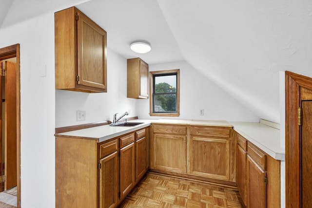 2 Howard St, Braintree, MA 02184 - kitchen featuring vaulted ceiling, light countertops, and brown cabinetry
