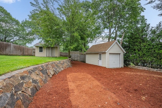 2 Howard St, Braintree, MA 02184 - fenced backyard with an outbuilding and a garage
