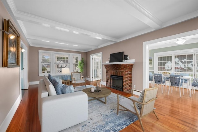 2 Howard St, Braintree, MA 02184 - living room featuring wood finished floors, beam ceiling, crown molding, and a brick fireplace