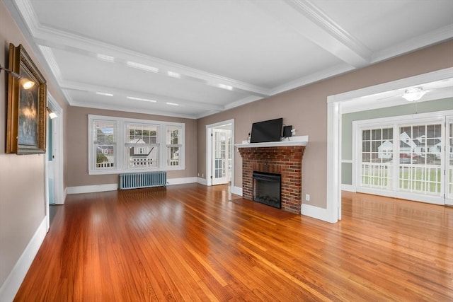 2 Howard St, Braintree, MA 02184 - unfurnished living room with radiator, wood finished floors, beam ceiling, a brick fireplace, and crown molding