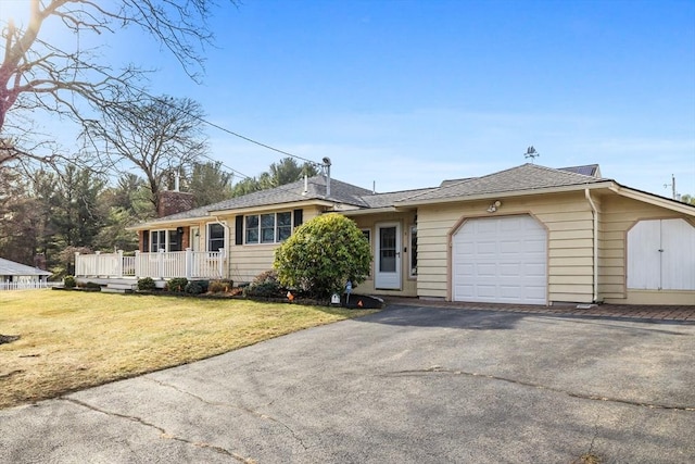 single story home featuring a garage and a front lawn