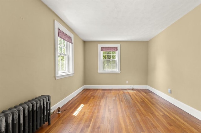 4 Grand St, Reading, MA 01867 - unfurnished room featuring radiator heating unit and light wood finished floors