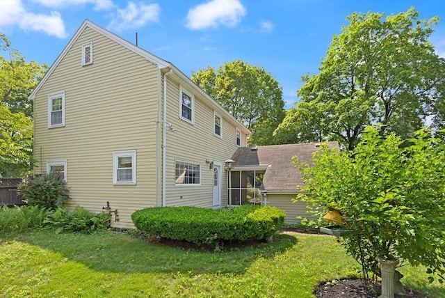 4 Grand St, Reading, MA 01867 - back of property featuring a yard and a sunroom