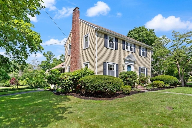 4 Grand St, Reading, MA 01867 - colonial-style house with a chimney and a front lawn