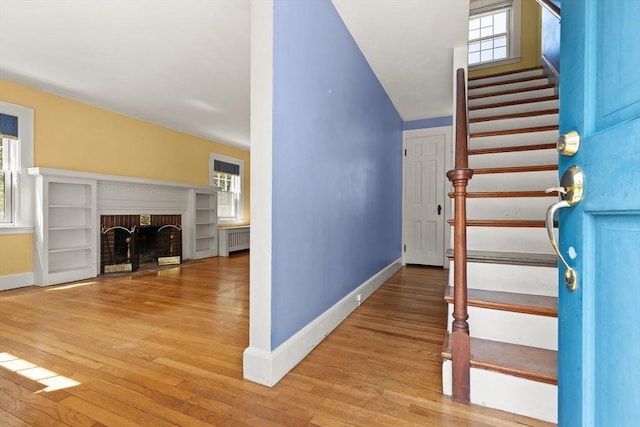 4 Grand St, Reading, MA 01867 - staircase with healthy amount of natural light, wood finished floors, a fireplace, and radiator heating unit