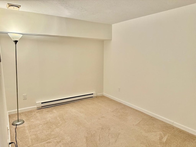basement with a baseboard radiator, carpet flooring, and baseboards
