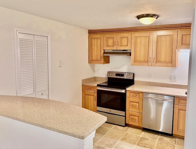 kitchen featuring light stone counters, under cabinet range hood, and stainless steel appliances