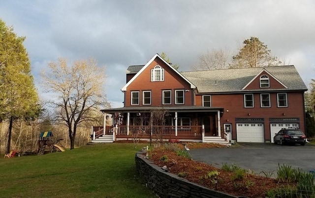 18 W Shore Dr, Goshen, MA 01032 - view of front facade featuring asphalt driveway, covered porch, a front yard, and an attached garage