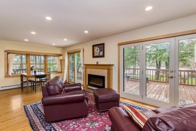 18 W Shore Dr, Goshen, MA 01032 - living room featuring recessed lighting, wood finished floors, baseboard heating, a fireplace, and french doors