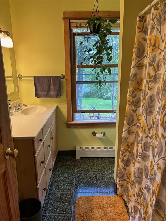 18 W Shore Dr, Goshen, MA 01032 - full bathroom with vanity, baseboards, and baseboard heating