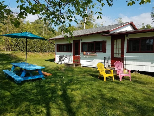 18 W Shore Dr, Goshen, MA 01032 - back of property with a yard and roof with shingles