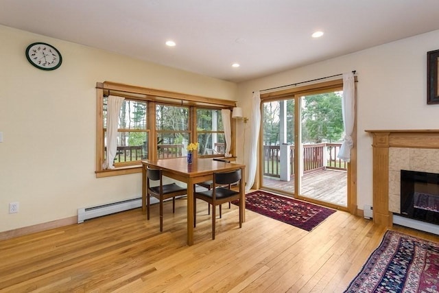 18 W Shore Dr, Goshen, MA 01032 - dining space featuring light wood-style flooring, a tiled fireplace, recessed lighting, baseboards, and a baseboard heating unit