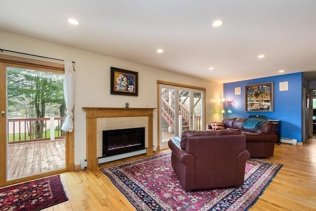 18 W Shore Dr, Goshen, MA 01032 - living area featuring a baseboard heating unit, a glass covered fireplace, wood finished floors, recessed lighting, and baseboards
