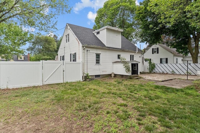 10 Jefferson St, Lawrence, MA 01843 - back of house featuring a gate, a fenced backyard, and roof with shingles