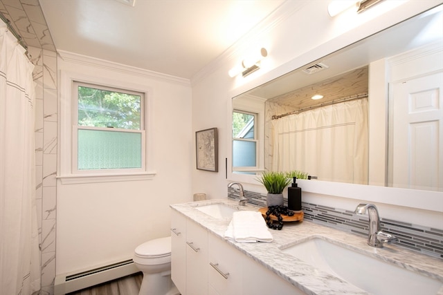 bathroom featuring toilet, hardwood / wood-style floors, baseboard heating, ornamental molding, and vanity