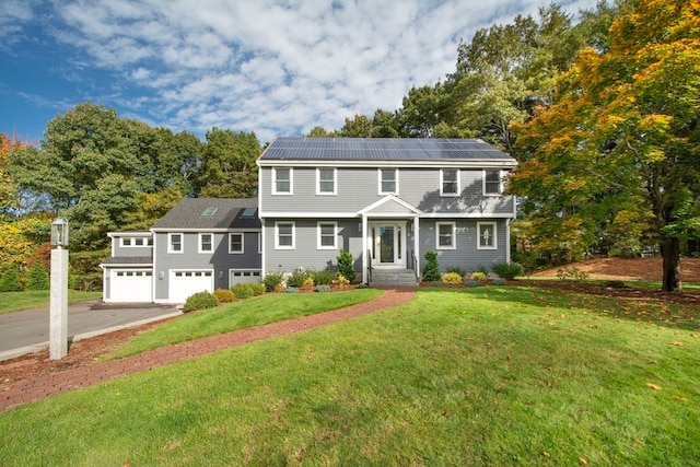 colonial house with solar panels and a front lawn