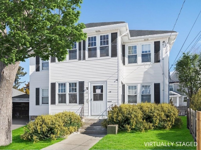 view of front of house with a front yard and fence