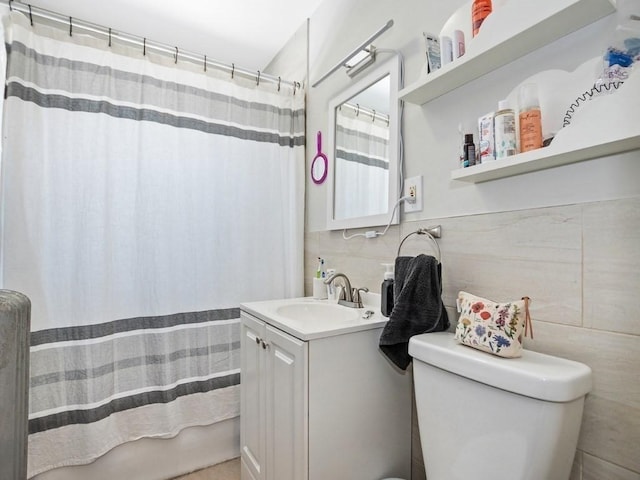 bathroom featuring a shower with shower curtain, toilet, tile walls, and vanity