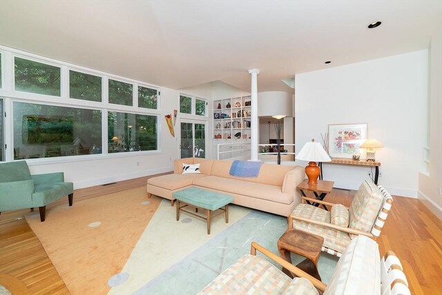 living area with baseboards and wood finished floors