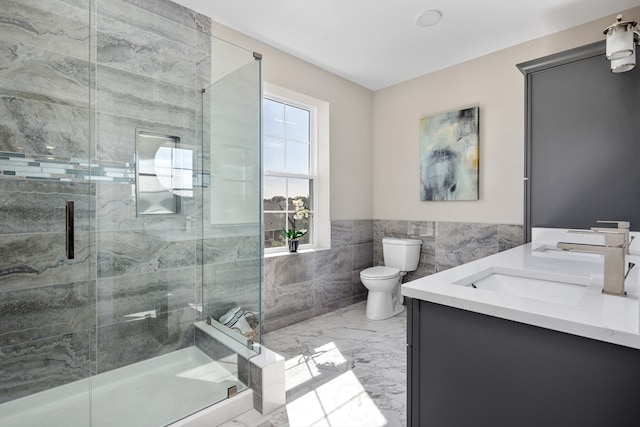 bathroom with walk in shower, vanity, tile walls, and toilet