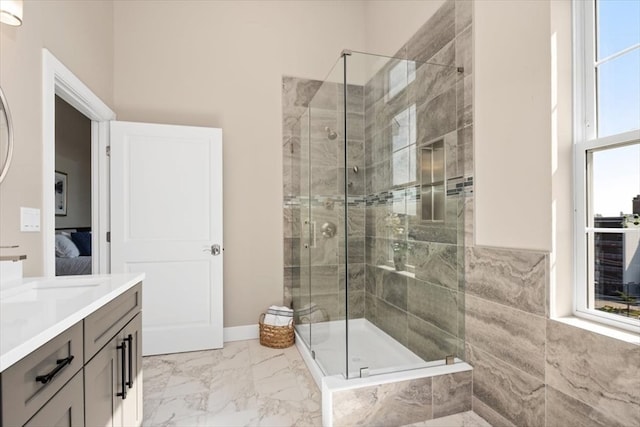 bathroom with vanity and a shower with shower door