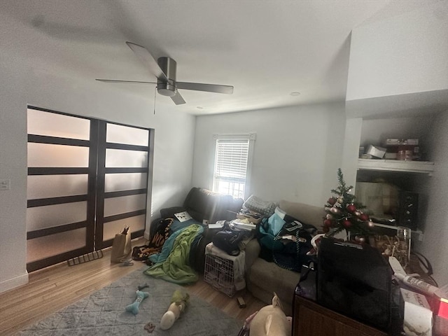 bedroom with a ceiling fan and wood finished floors