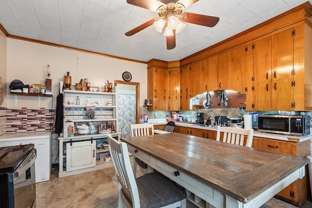 dining space featuring crown molding and ceiling fan