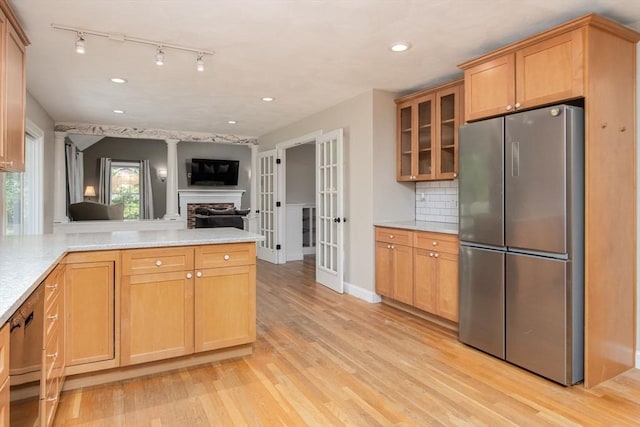 3 Integrity Way, Groton, MA 01450 - kitchen featuring freestanding refrigerator, light wood-style floors, open floor plan, glass insert cabinets, and a peninsula