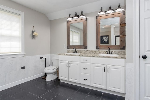 3 Integrity Way, Groton, MA 01450 - full bathroom featuring wainscoting, tile walls, double vanity, tile patterned floors, and vaulted ceiling