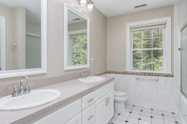 3 Integrity Way, Groton, MA 01450 - bathroom featuring plenty of natural light, tile walls, double vanity, tile patterned flooring, and a wainscoted wall