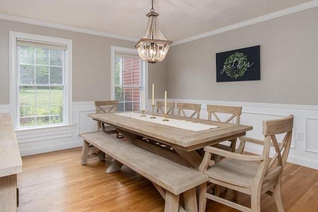 3 Integrity Way, Groton, MA 01450 - dining area featuring a chandelier, a wainscoted wall, light wood finished floors, crown molding, and healthy amount of natural light