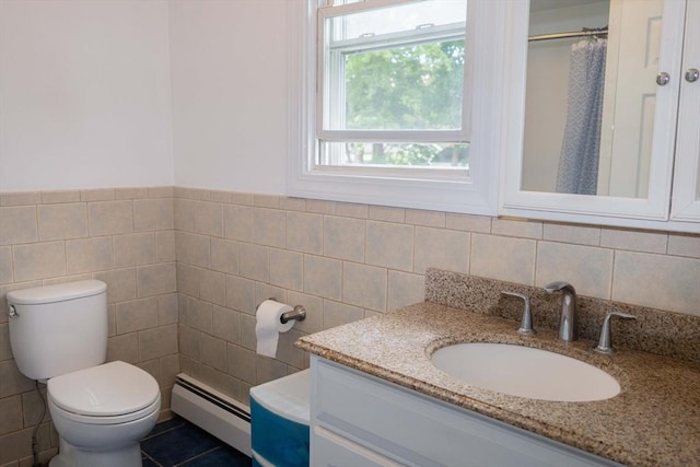 69 Front St, Shirley, MA 01464 - bathroom with a baseboard heating unit, tile walls, vanity, toilet, and curtained shower