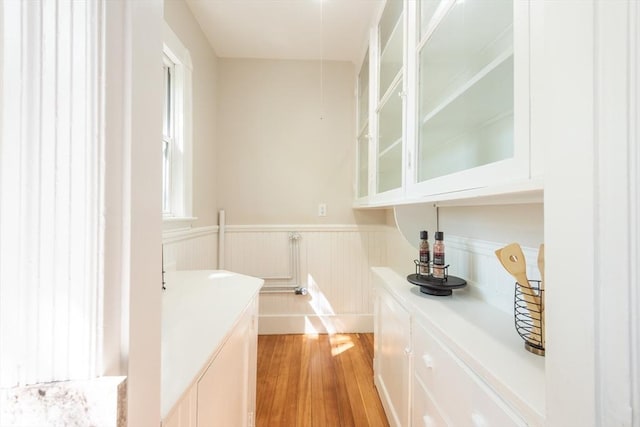 1690 Centre St Unit 2, Boston, MA 02132 - bar featuring wainscoting and light wood-style flooring