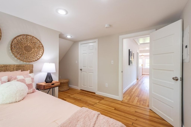1690 Centre St Unit 2, Boston, MA 02132 - bedroom featuring attic access, light wood-type flooring, baseboards, recessed lighting, and lofted ceiling