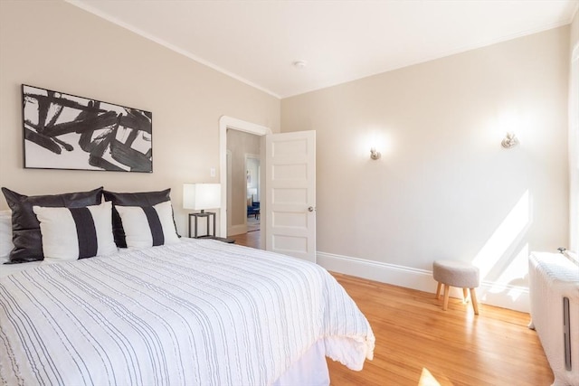 1690 Centre St Unit 2, Boston, MA 02132 - bedroom featuring wood finished floors, radiator heating unit, baseboards, and ornamental molding