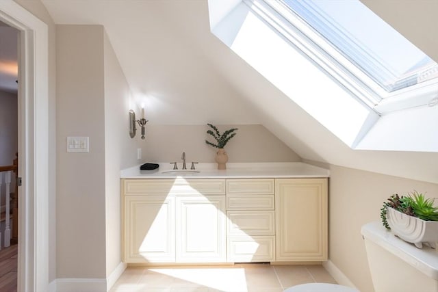 1690 Centre St Unit 2, Boston, MA 02132 - bar featuring a skylight, a sink, vaulted ceiling, and baseboards