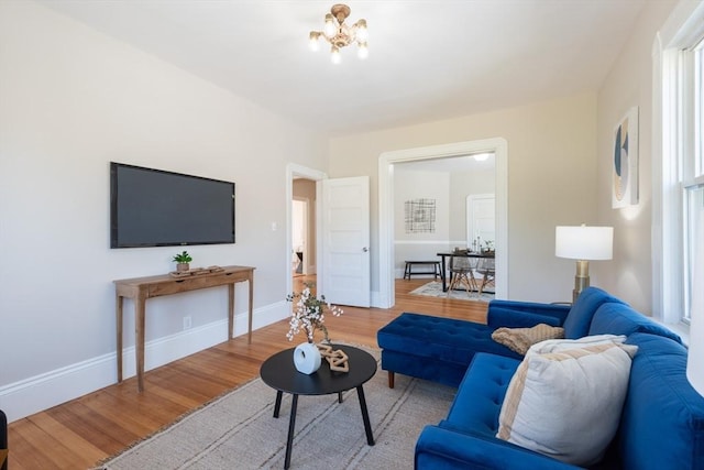 1690 Centre St Unit 2, Boston, MA 02132 - living area featuring wood finished floors, baseboards, and a chandelier