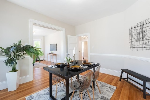 1690 Centre St Unit 2, Boston, MA 02132 - dining space with light wood-type flooring, a chandelier, and baseboards
