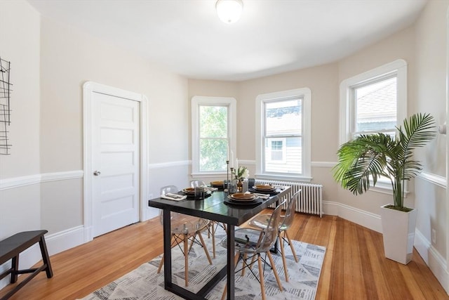 1690 Centre St Unit 2, Boston, MA 02132 - dining area featuring radiator heating unit, light wood-style flooring, and baseboards