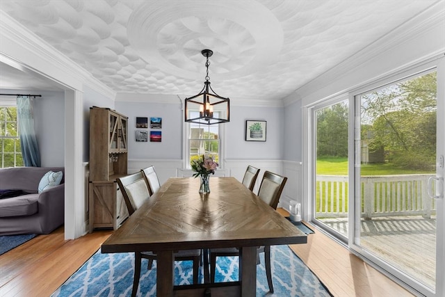 26 Dodge Rd, Sutton, MA 01590 - dining area featuring light wood-style floors, wainscoting, a chandelier, and ornamental molding