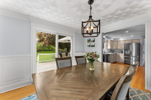 26 Dodge Rd, Sutton, MA 01590 - dining space featuring a chandelier, wainscoting, ornamental molding, and light wood-type flooring