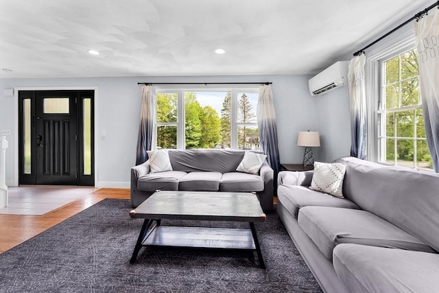 26 Dodge Rd, Sutton, MA 01590 - living area with a wall unit AC, recessed lighting, wood finished floors, and baseboards