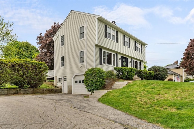 26 Dodge Rd, Sutton, MA 01590 - colonial inspired home featuring a garage, driveway, a front lawn, and a chimney