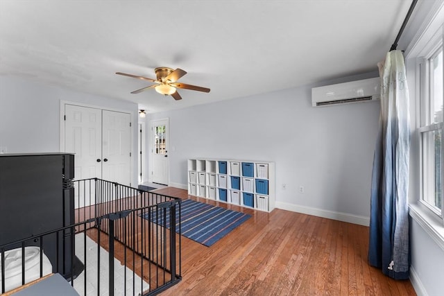 26 Dodge Rd, Sutton, MA 01590 - unfurnished room with a wall mounted AC, baseboards, ceiling fan, and hardwood / wood-style floors